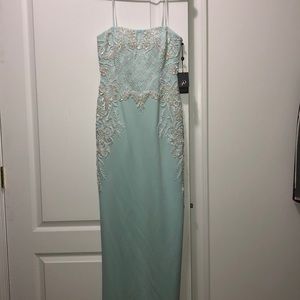 Long, strapless aqua/mint color dress.